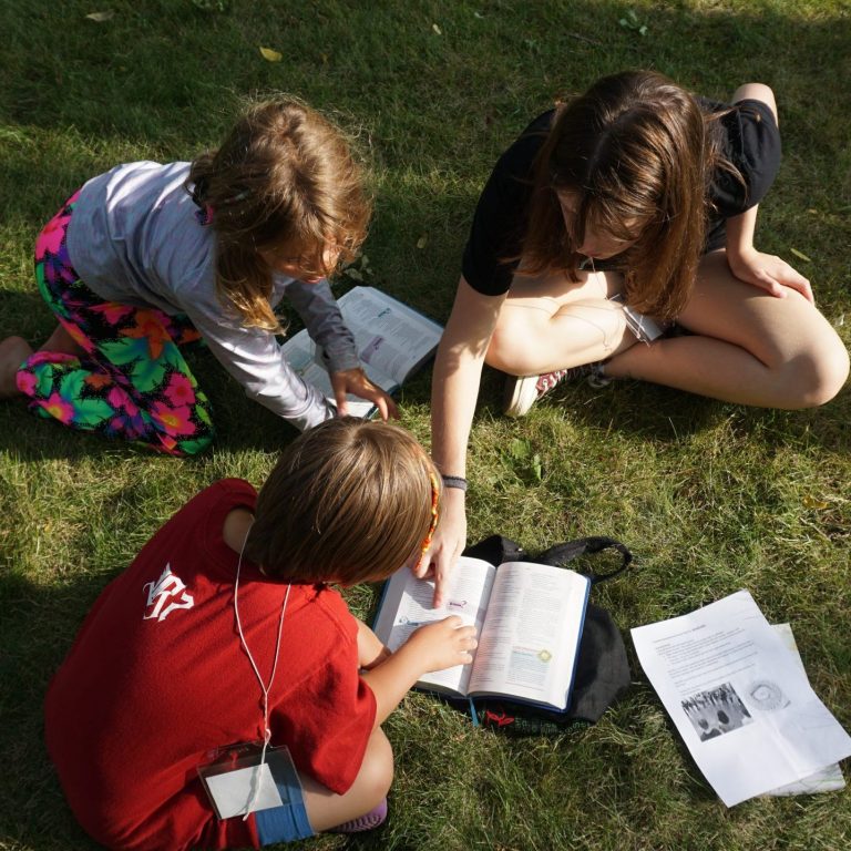 Campers reading a bible story